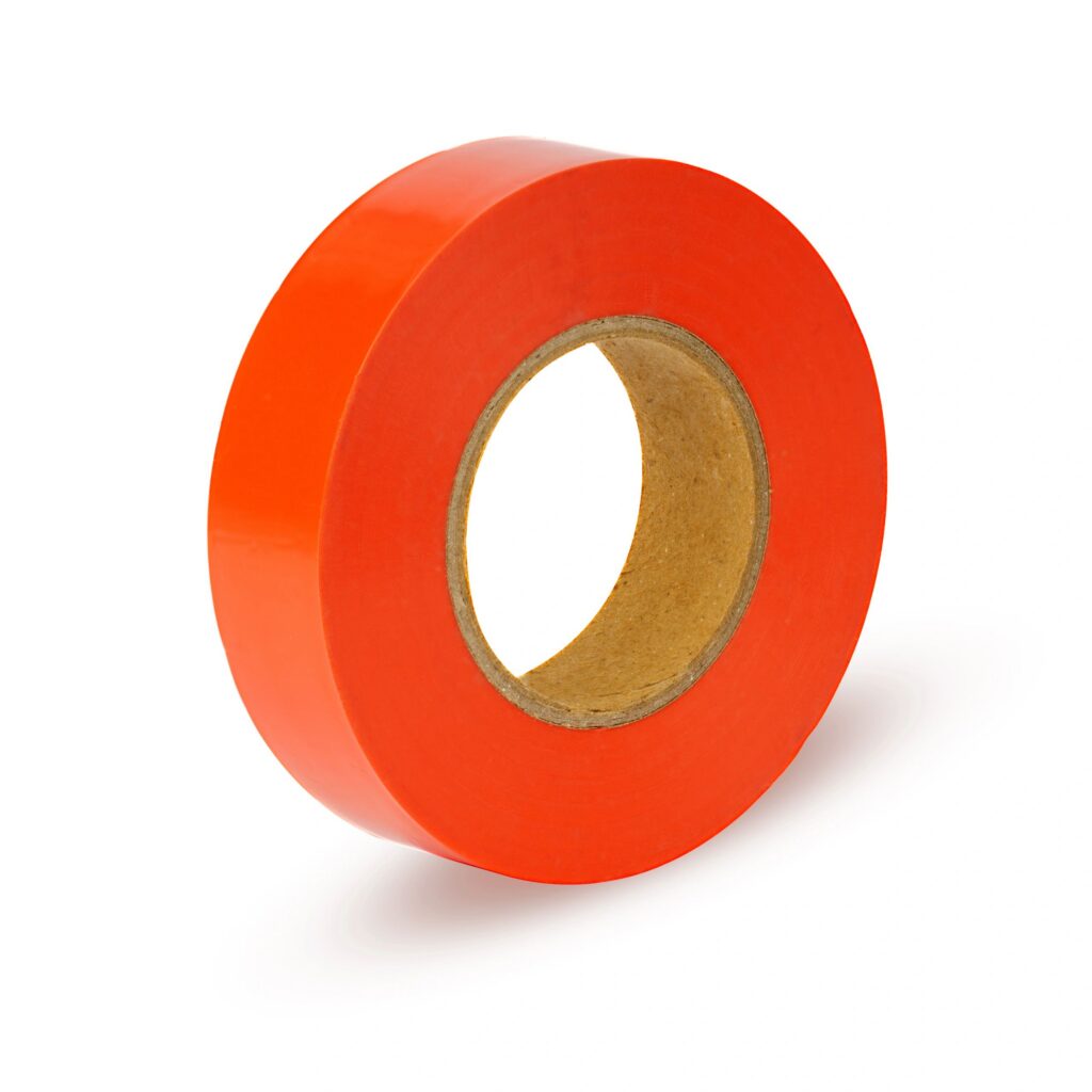 roll of red plastic adhesive tape isolated on white
