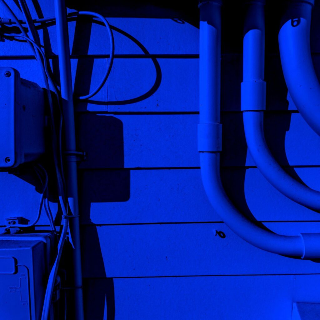 Utility lines on exterior of building wall